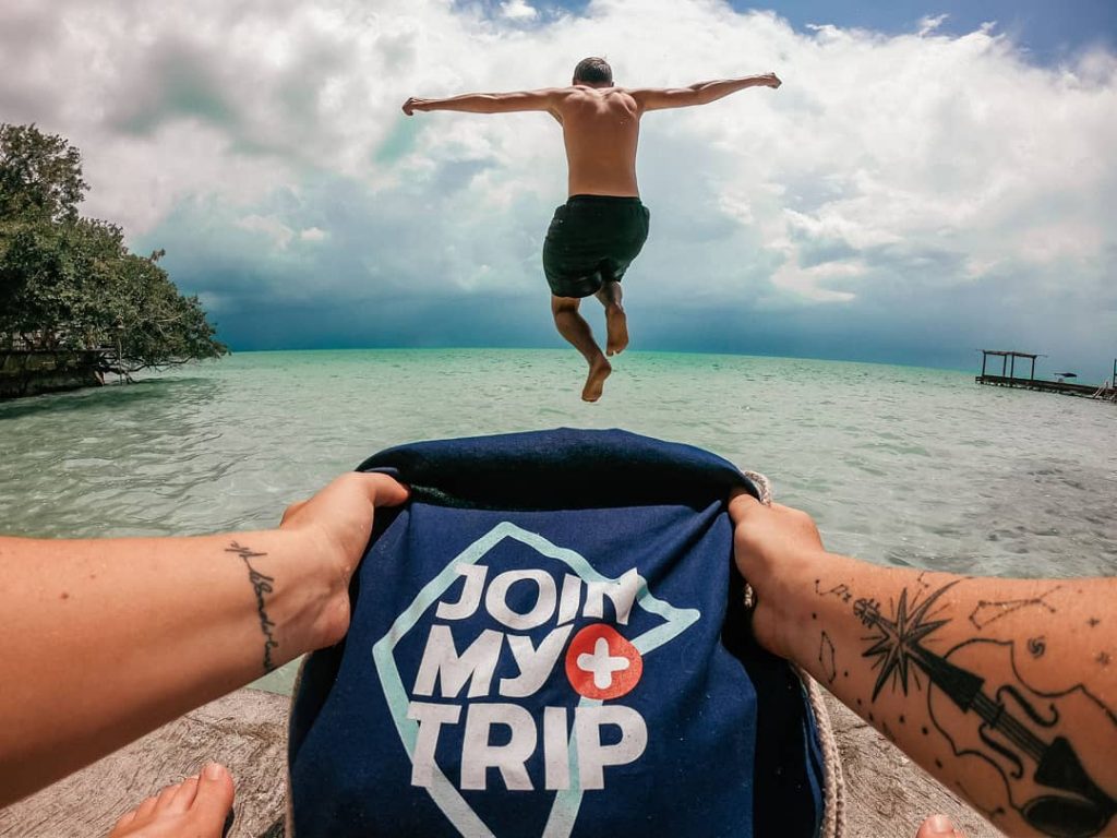 A person jumping into water in a tropical country