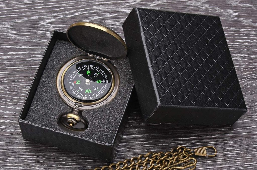 A compass as a travel essential for adventure trips in a black box.