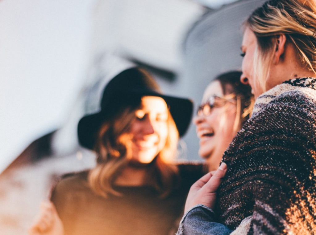 3 women traveling together and having fun together as a group.