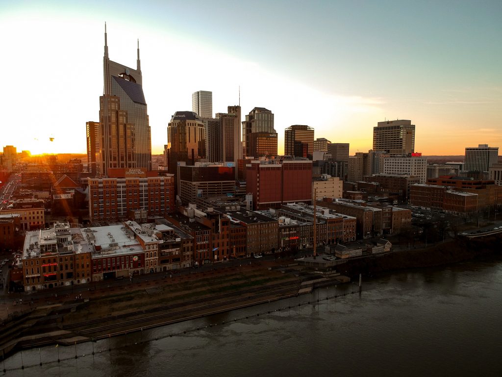 The best city to live in America is Nashville, Tennessee with a view of the city with the sun setting