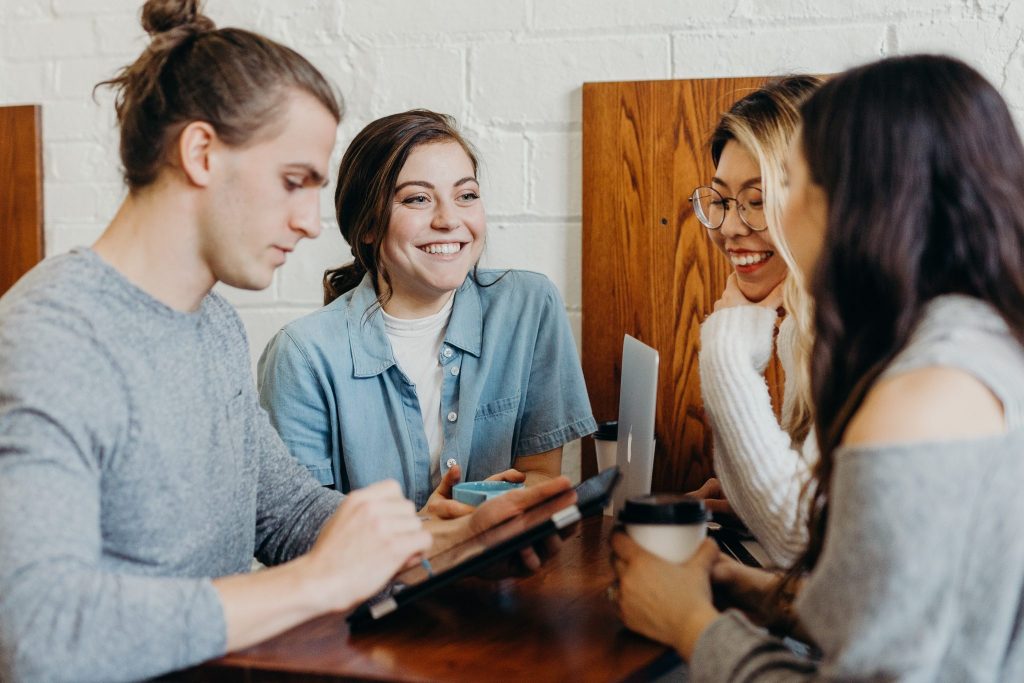 4 young people communicating on their group trip.