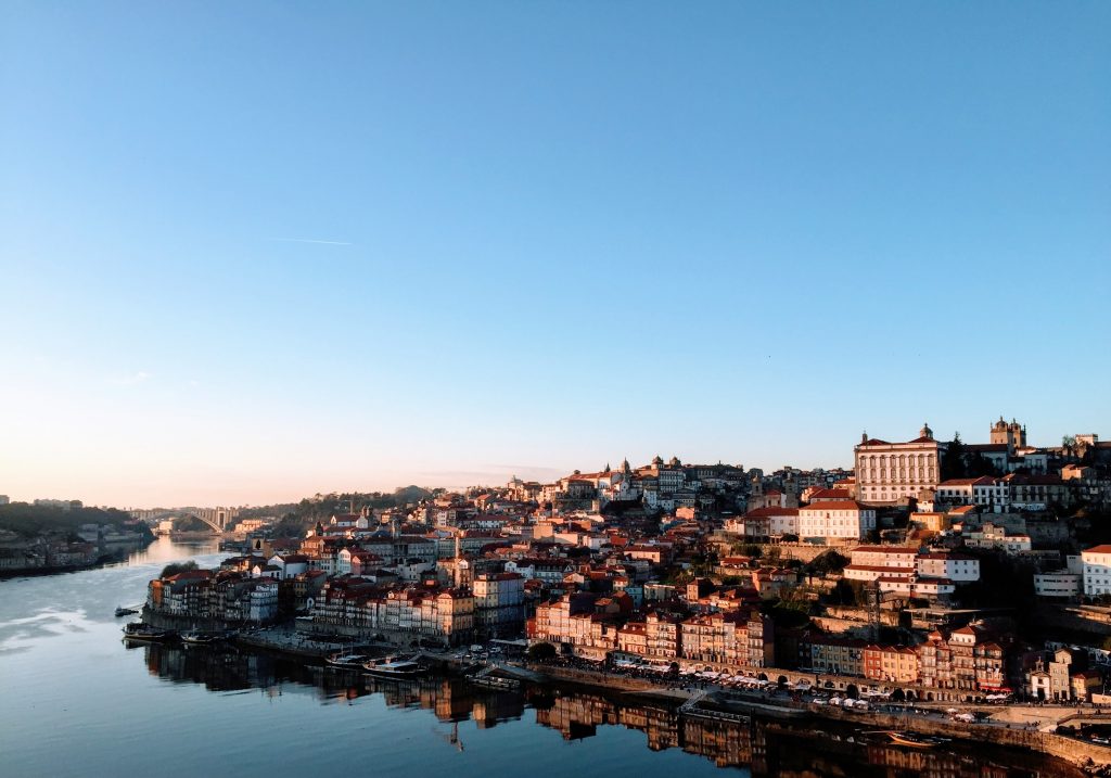 a view of Porto in Portugal during the sunset with the river.