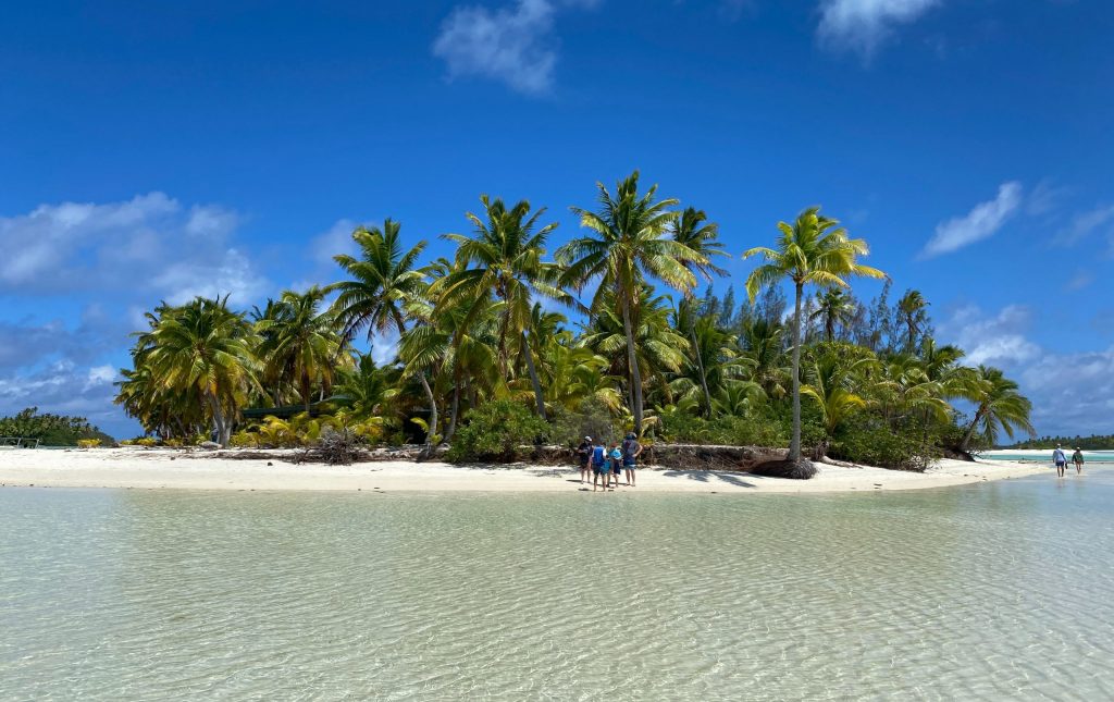 Cook Islands in the South Pacific with blue sky and clear water on a white sandy beach