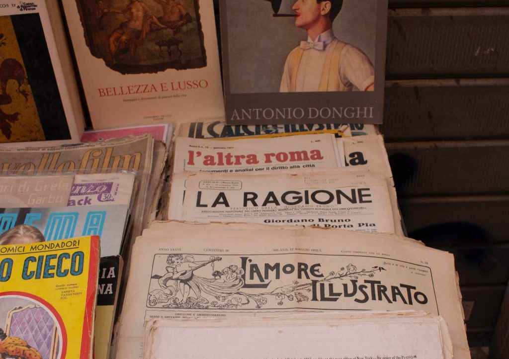 a stack of newspaper laid out on a stall.