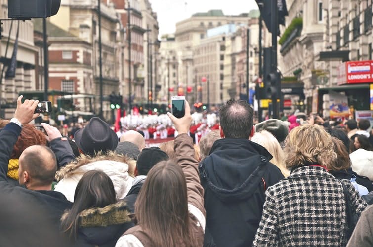 A huge crowd of people standing close by in London 