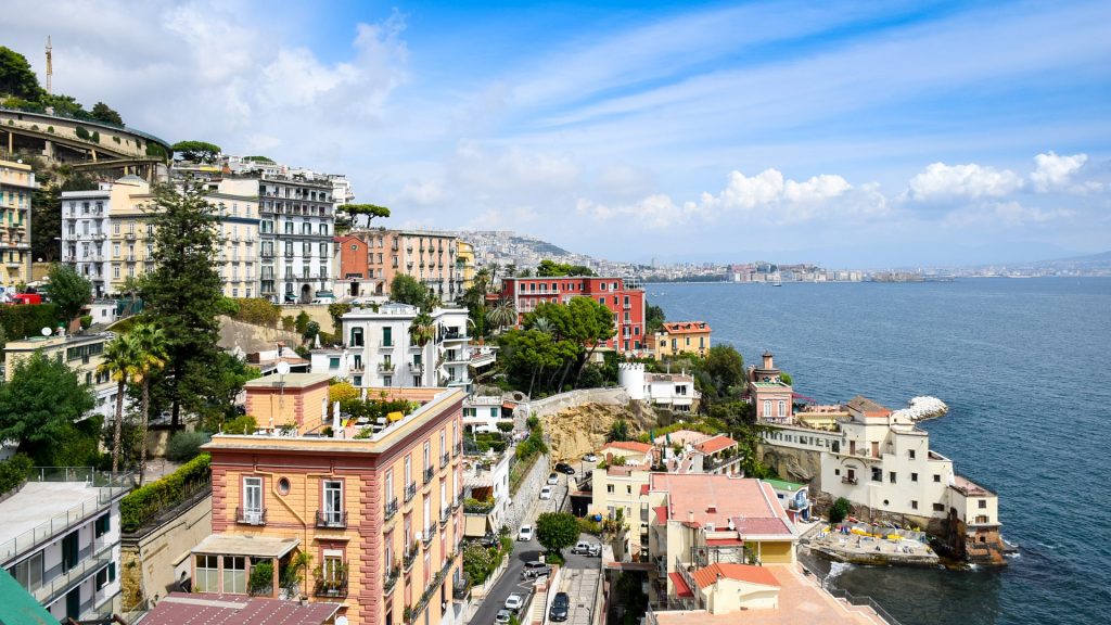 Naples is one of the best places to visit in Italy with a stunning view of houses by the water.