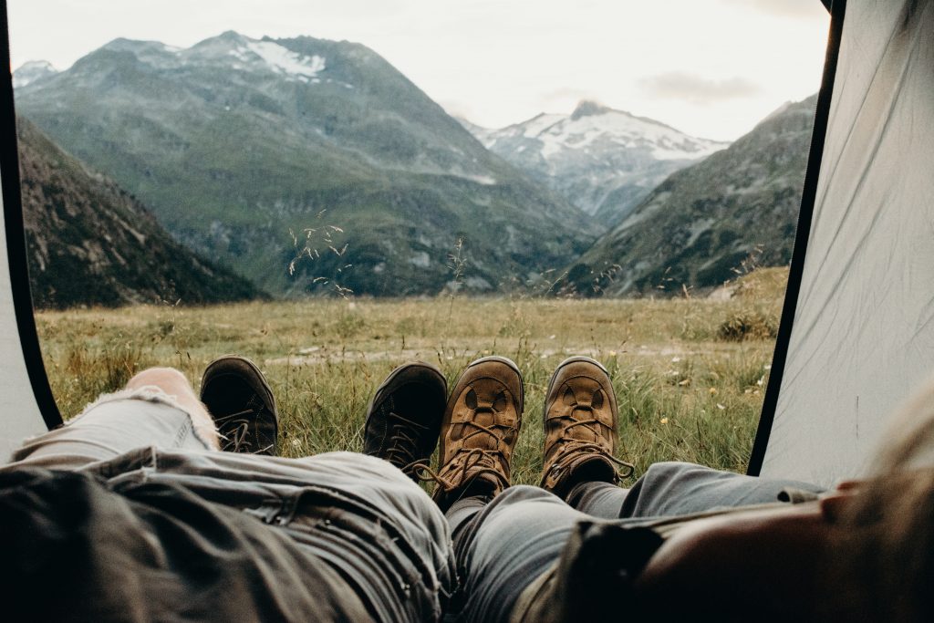 People that are lying in the car and have a mountains view