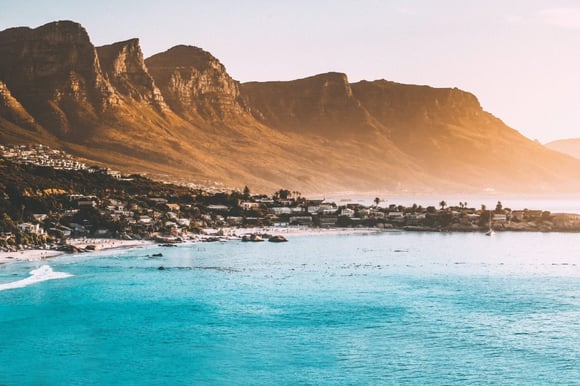 The coast of cape town with blue water and huge mountains