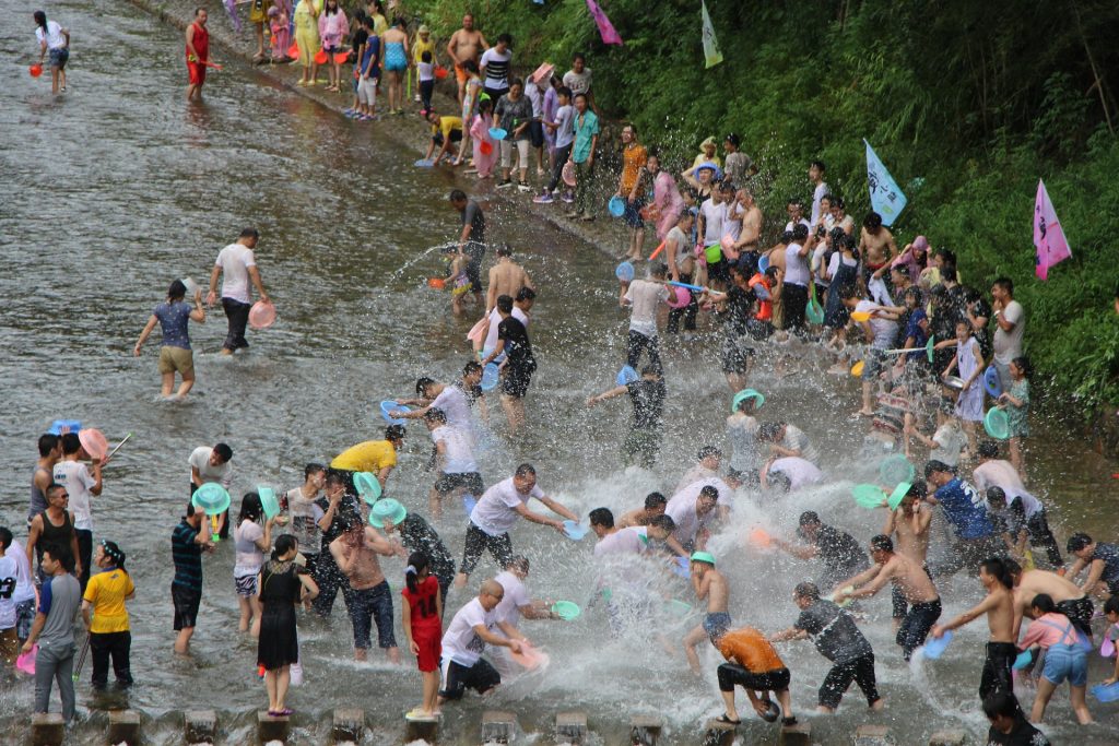 a New Years tradition around the world in Thailand of songkran where people throw water at each other.