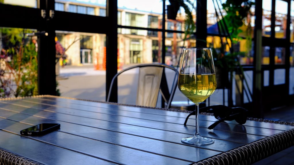 Glass of wine with historic buildings in background