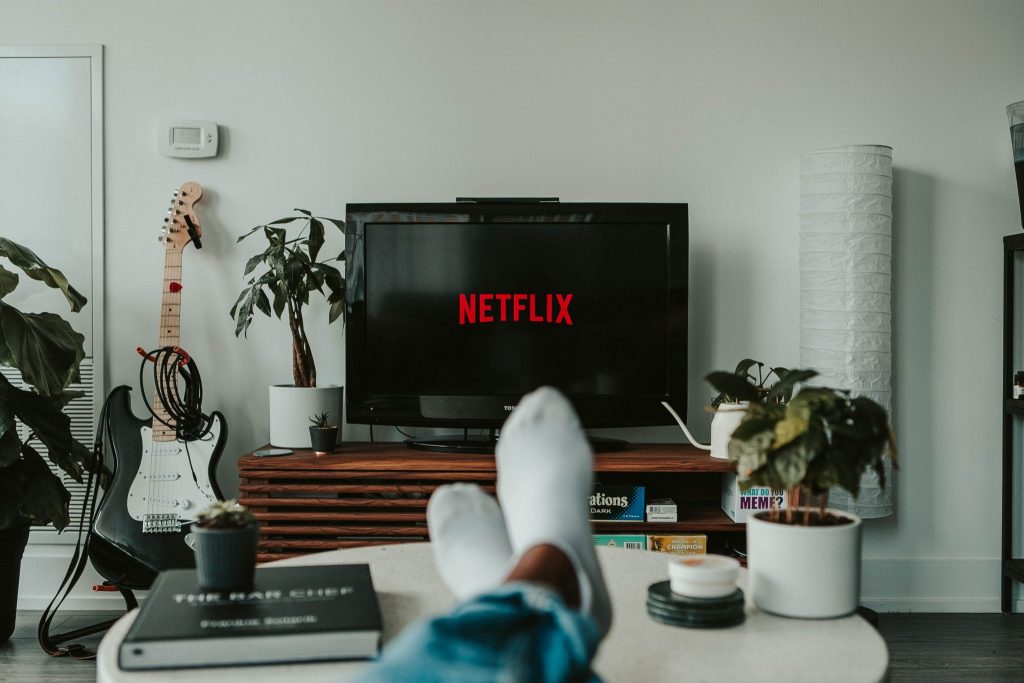 Someone has put his feet comfortably on the coffee table while watching movies matching the theme of Carnival 2021.