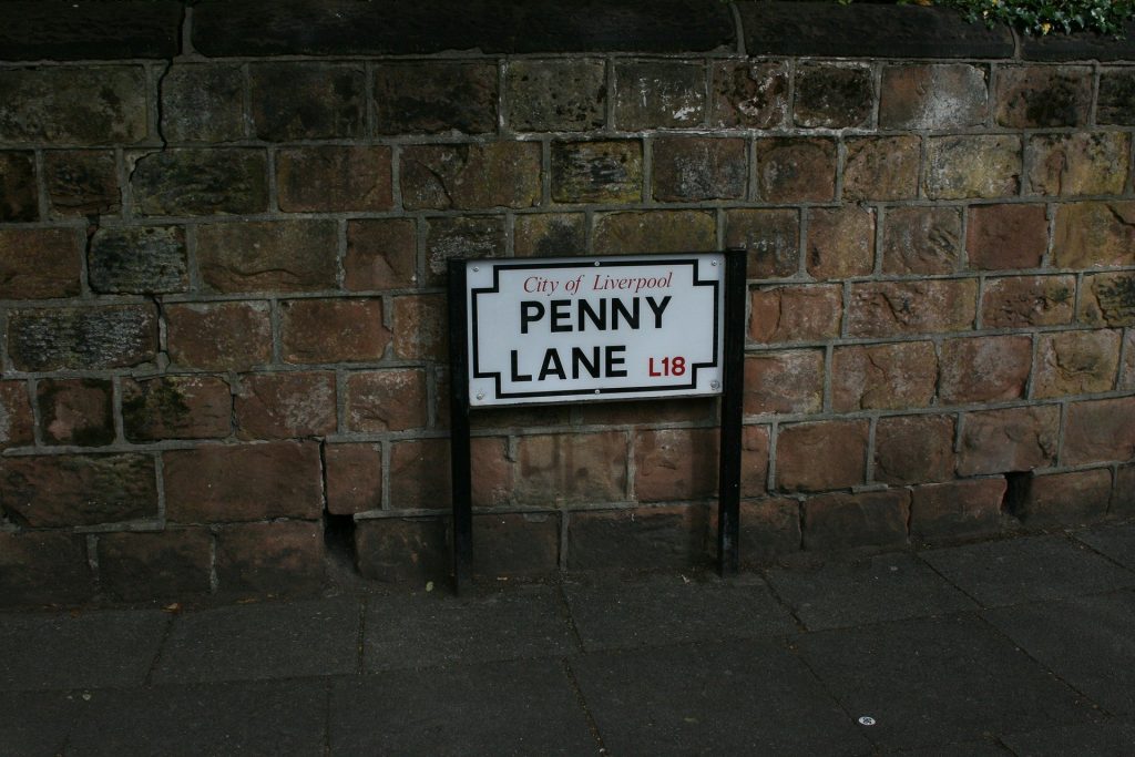 Street sign of Penny Lane against a brick wall