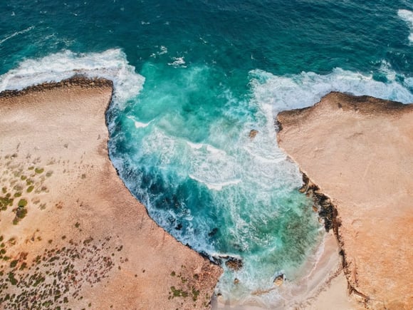 the spectacular island, Aruba, showing the bright blue waves in a beautiful cove