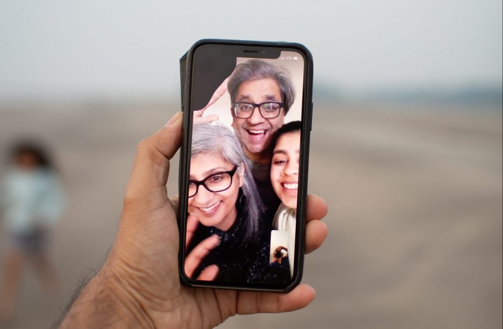 a hand video calling their family with an iPhone during the winter lockdown