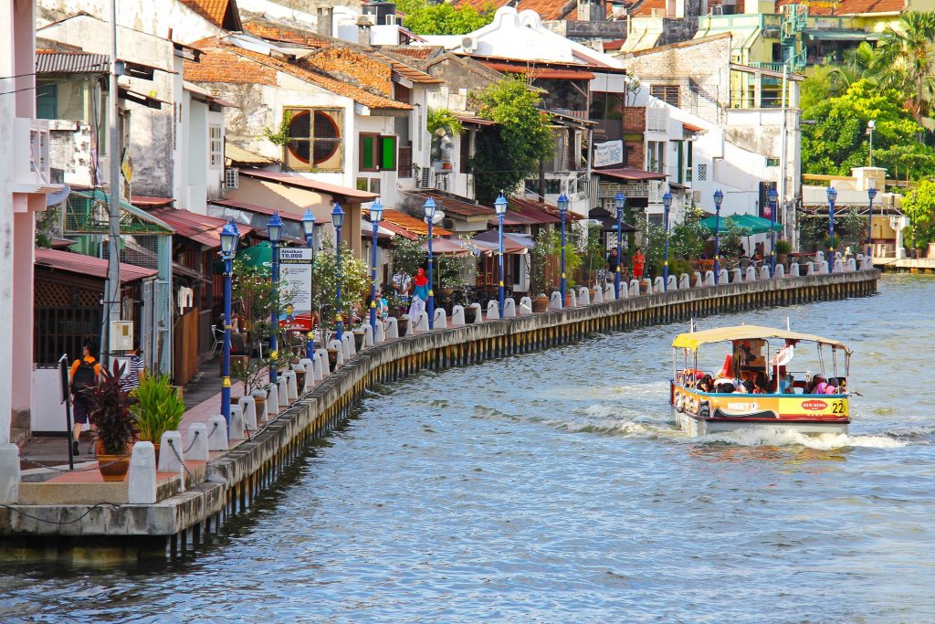 Melaka in Malaysia with the river and boat cruising through.