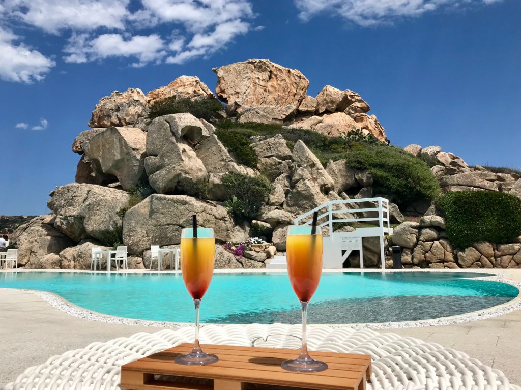 Drinks by a pool with rock structures in the background