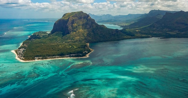 a view of Mauritius with blue sea and green mountains during the travel news