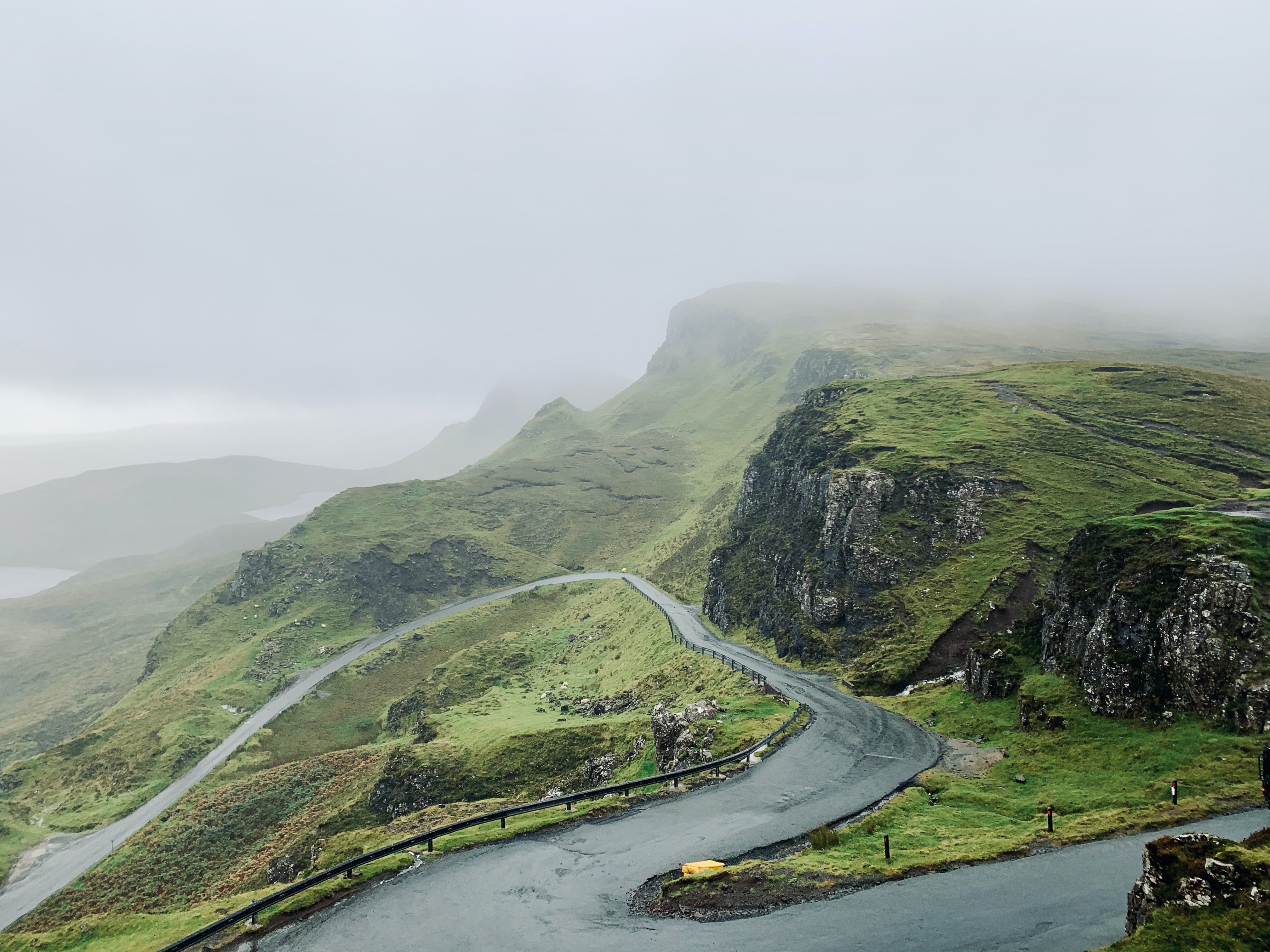 Lush green hills in Scotland on a foggy day