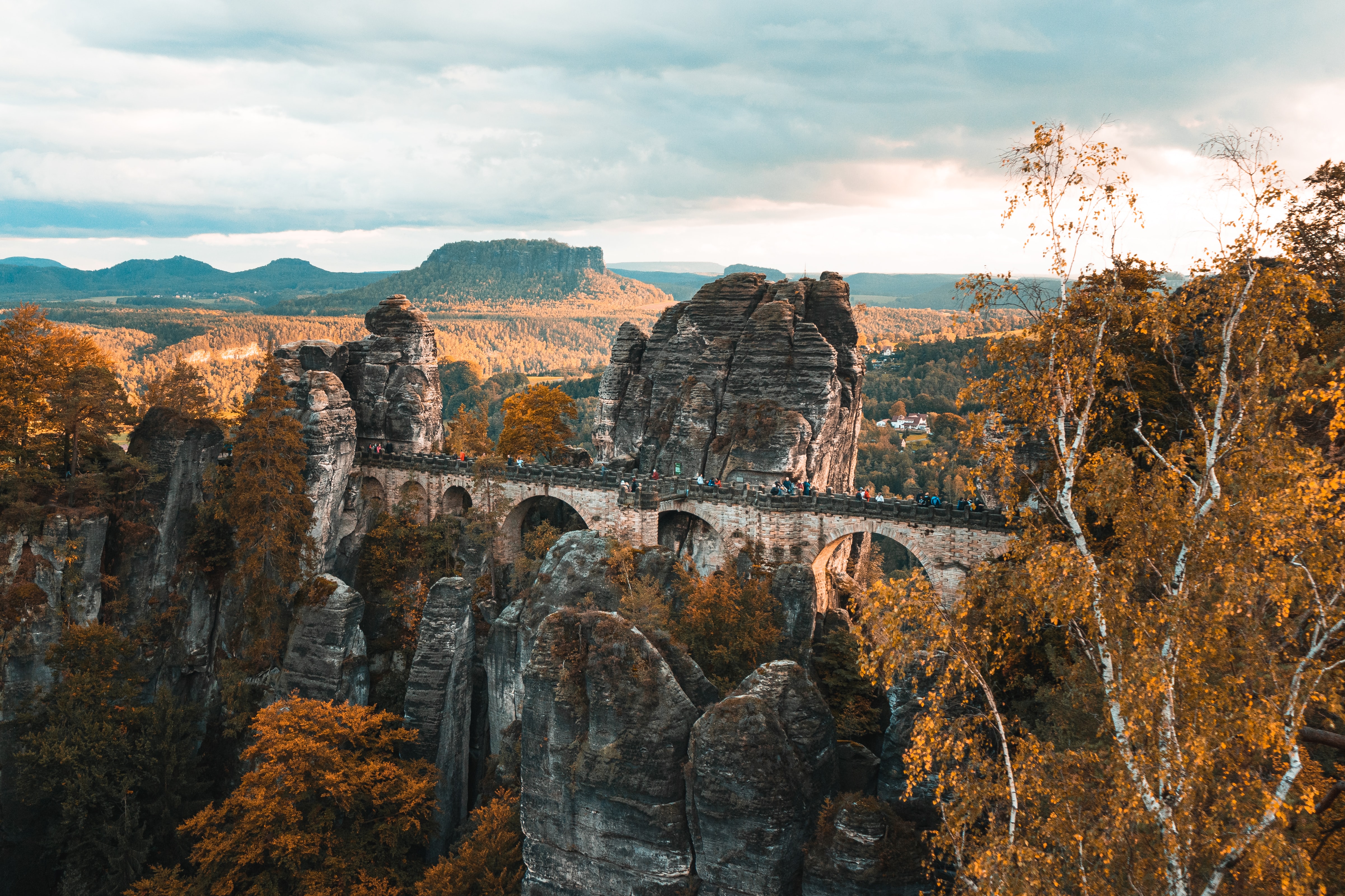 Autumn colors around a stone bridge surrounded with rock formations and nature