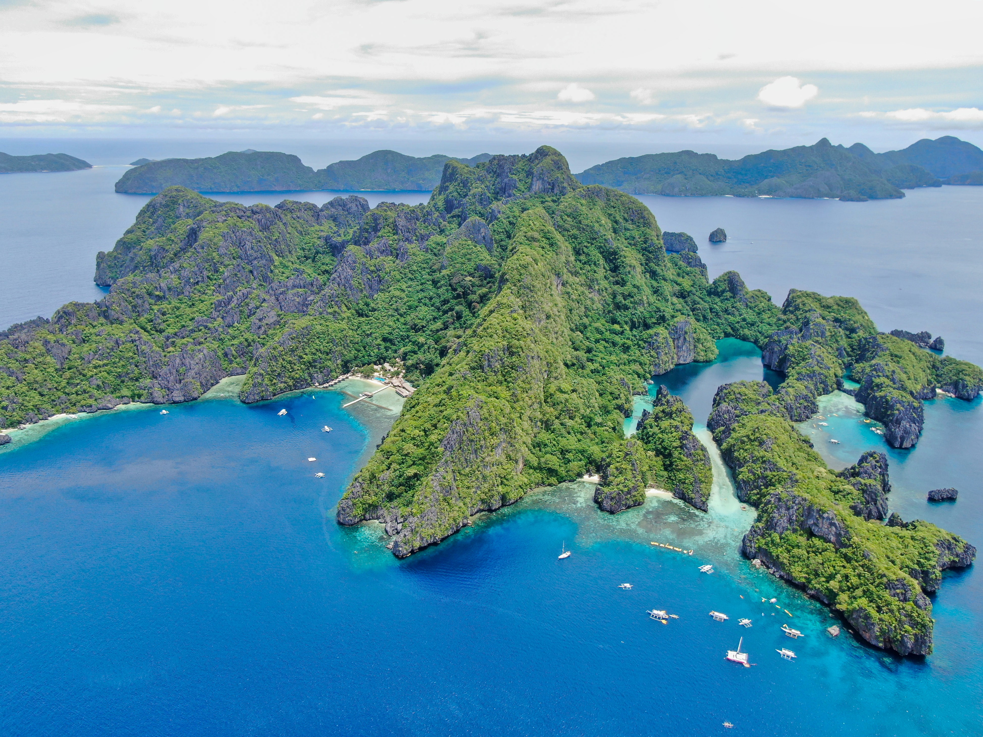 Limestone cliff islands in Palawan surrounded by blue waters