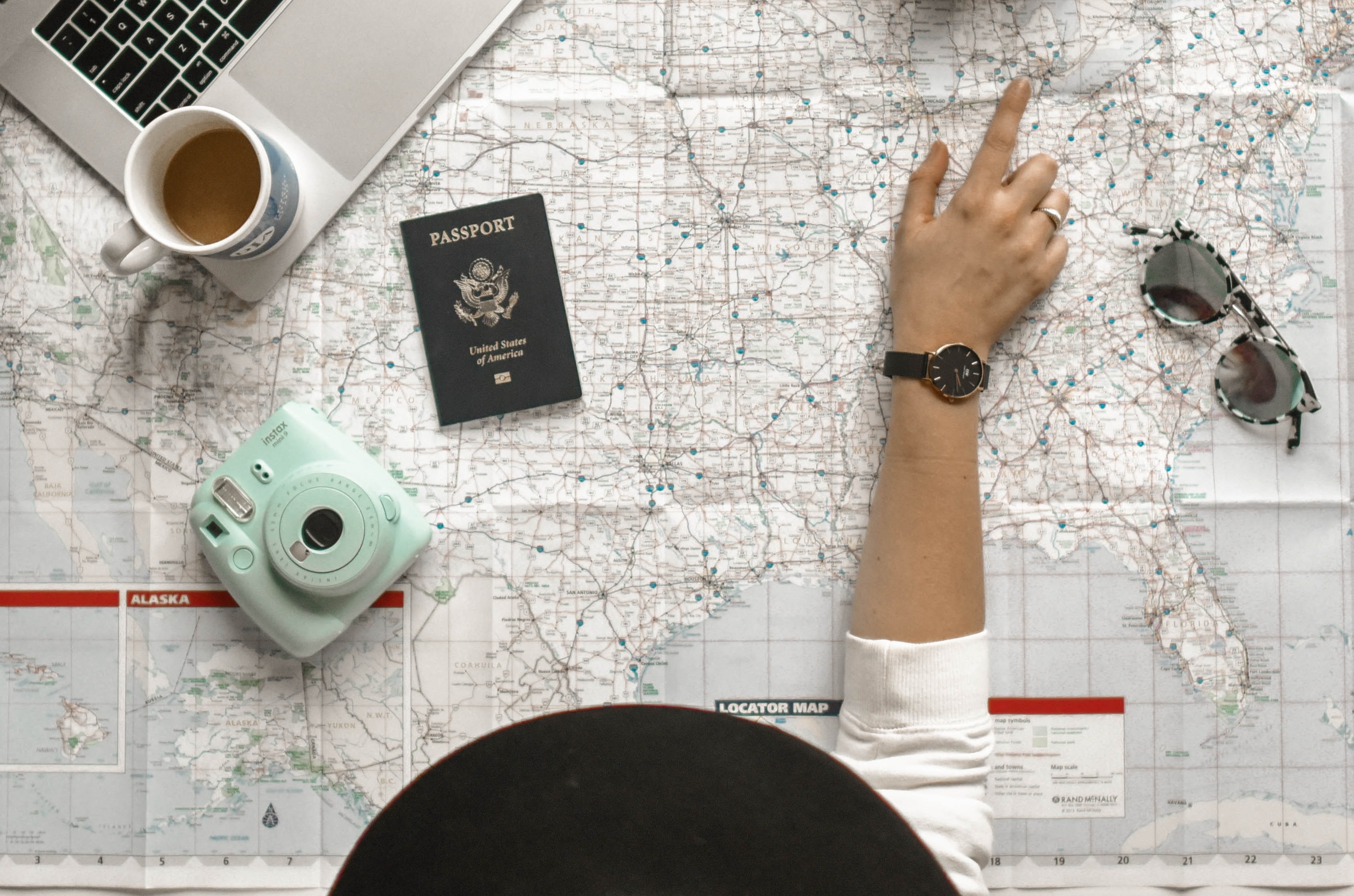 A girl pointing with her fingers on a spot in a map to plan the perfect group trip.