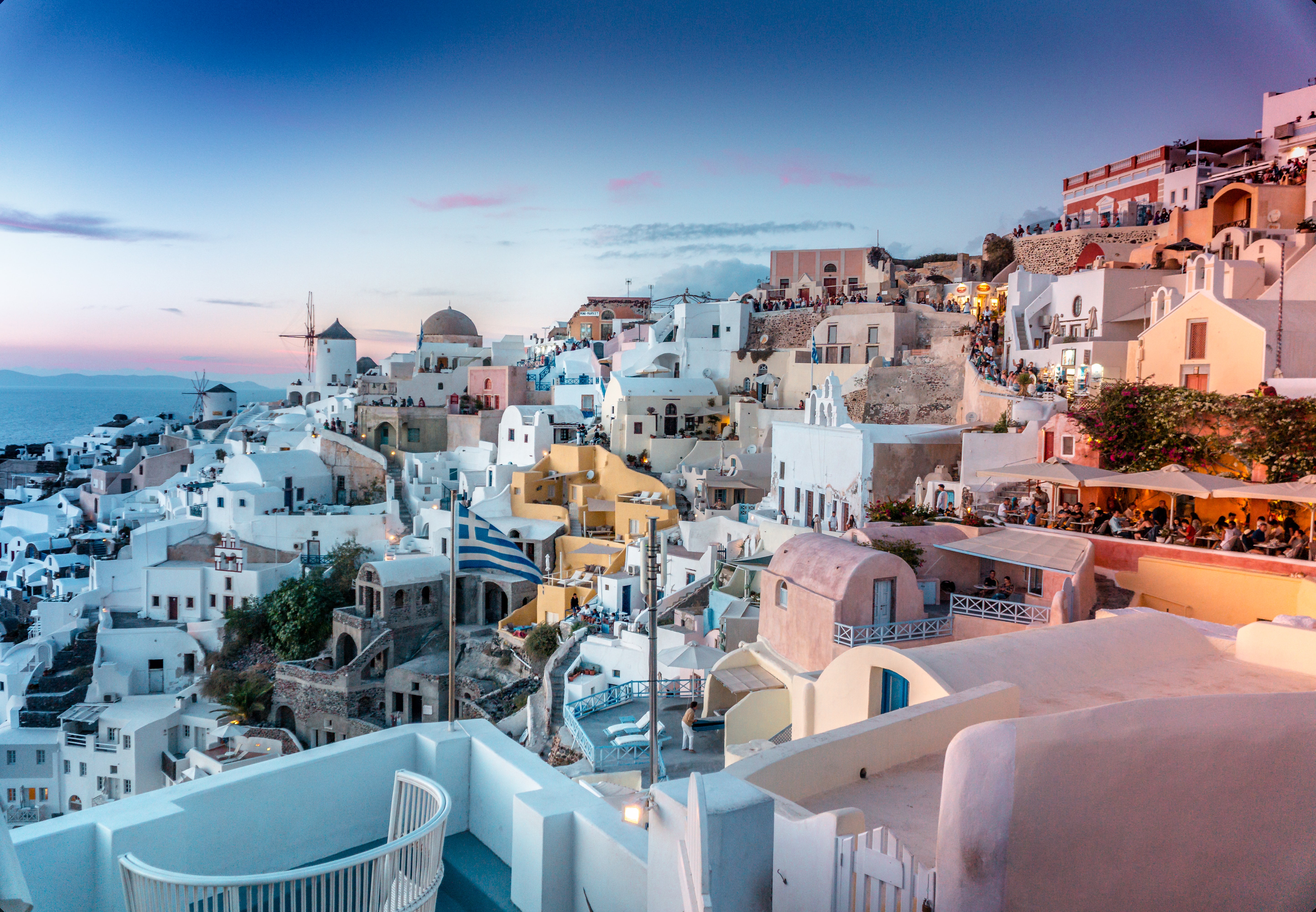 white-washed houses on the island of Santorini in Greece at sunset