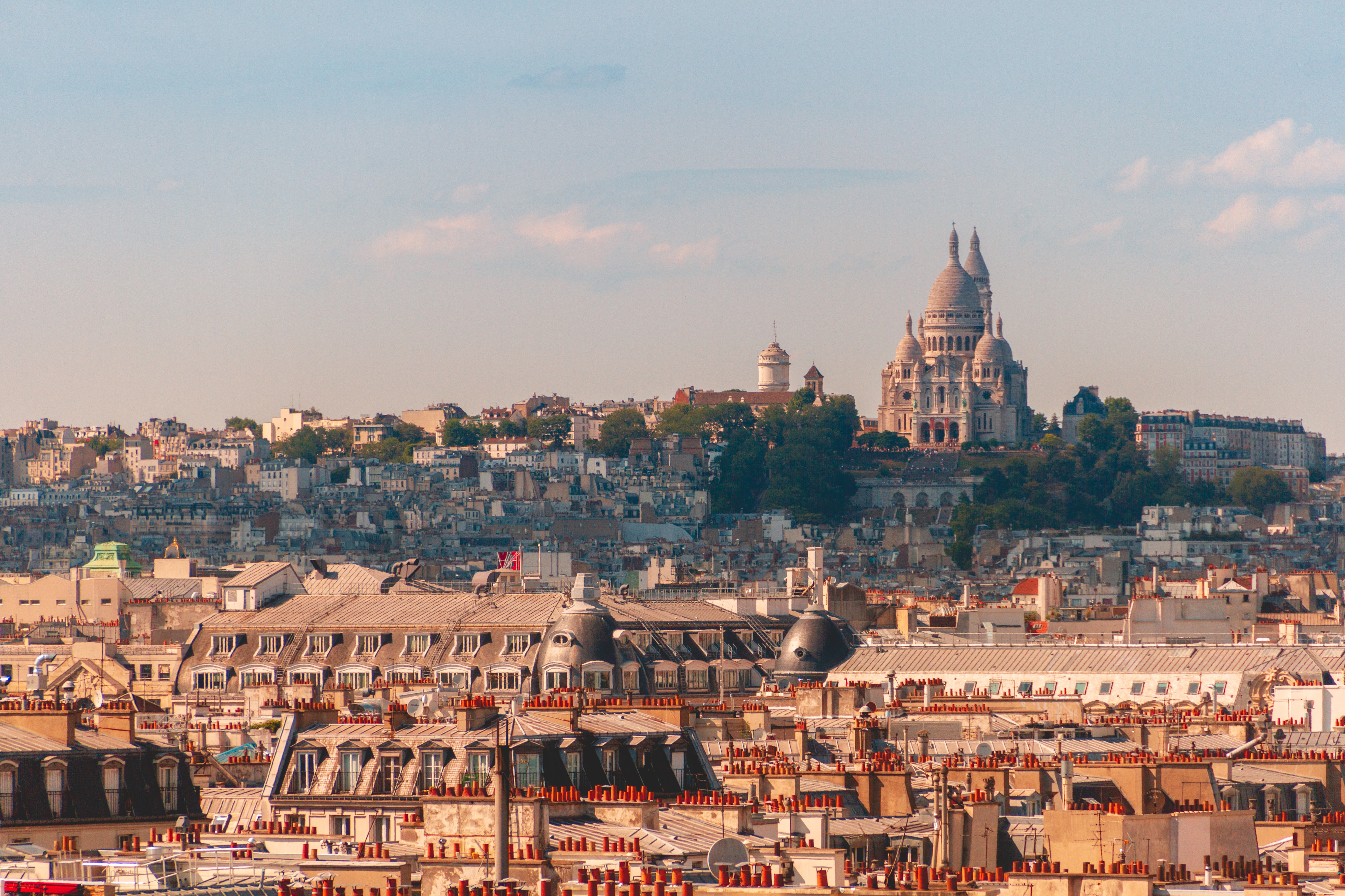 Old buildings and a church on a hill in Paris at sunset