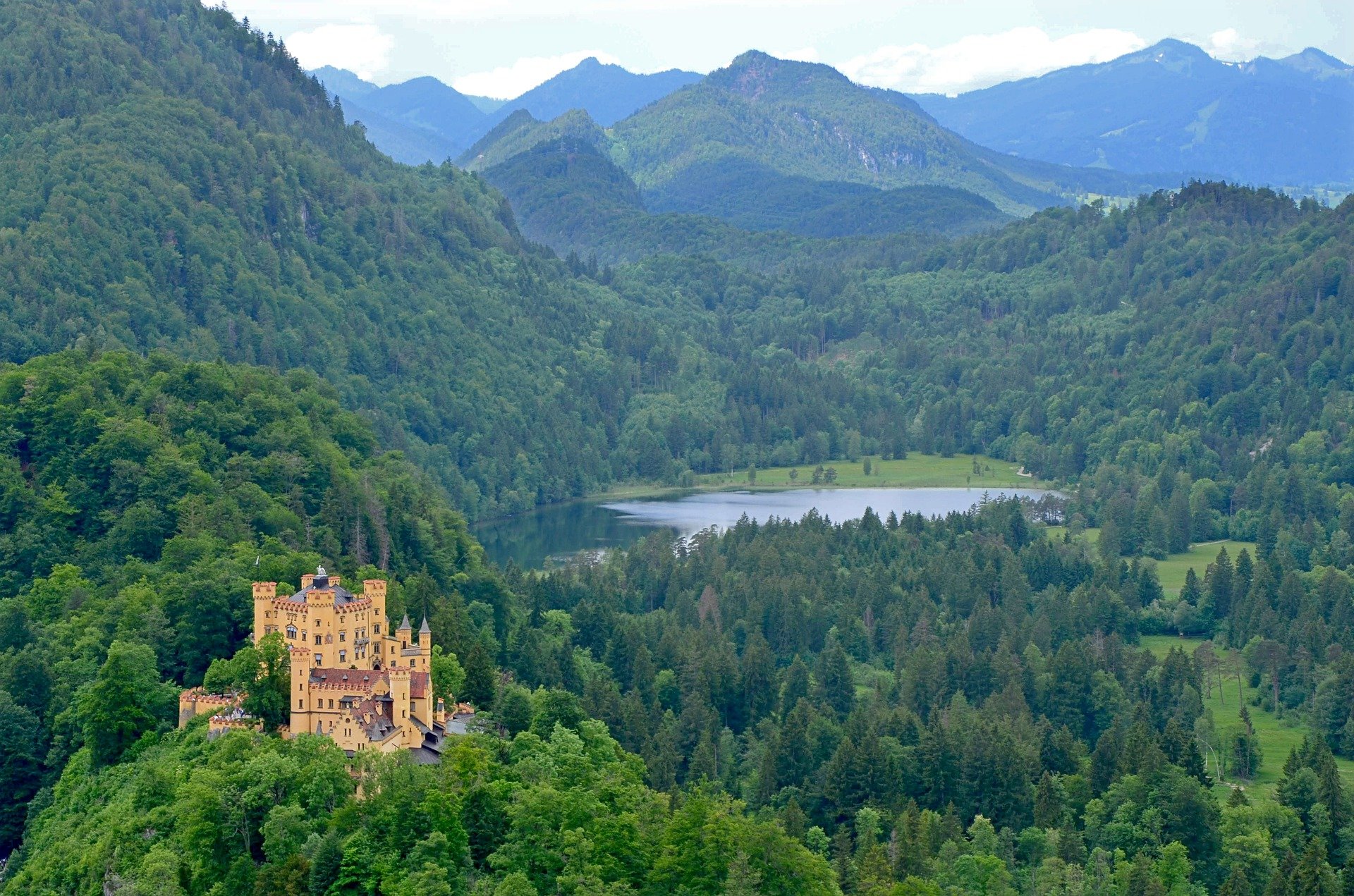 Castle in Germany surrounded by forests and hills and lake