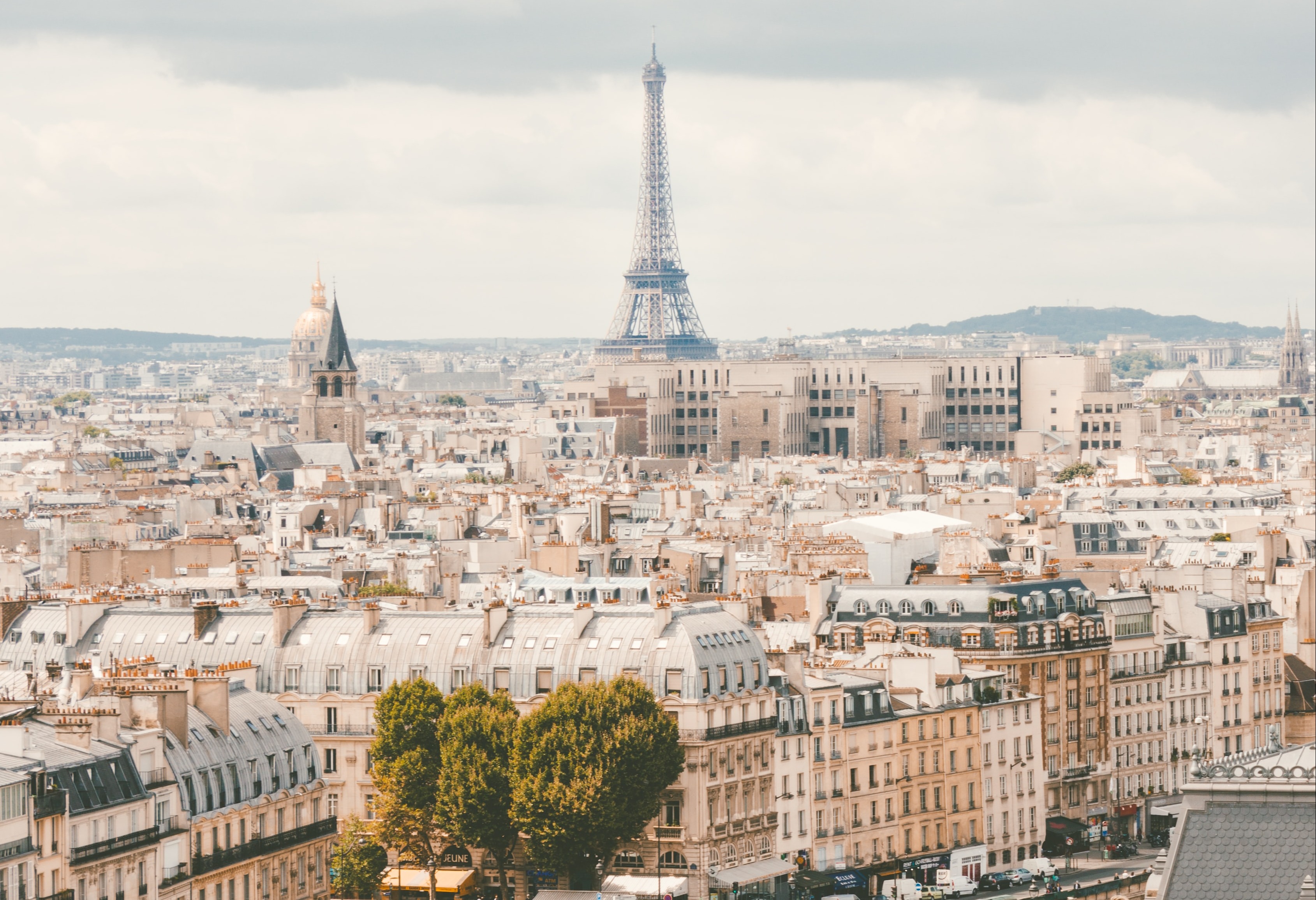 A city view of france with the Eiffel tower in the distance.