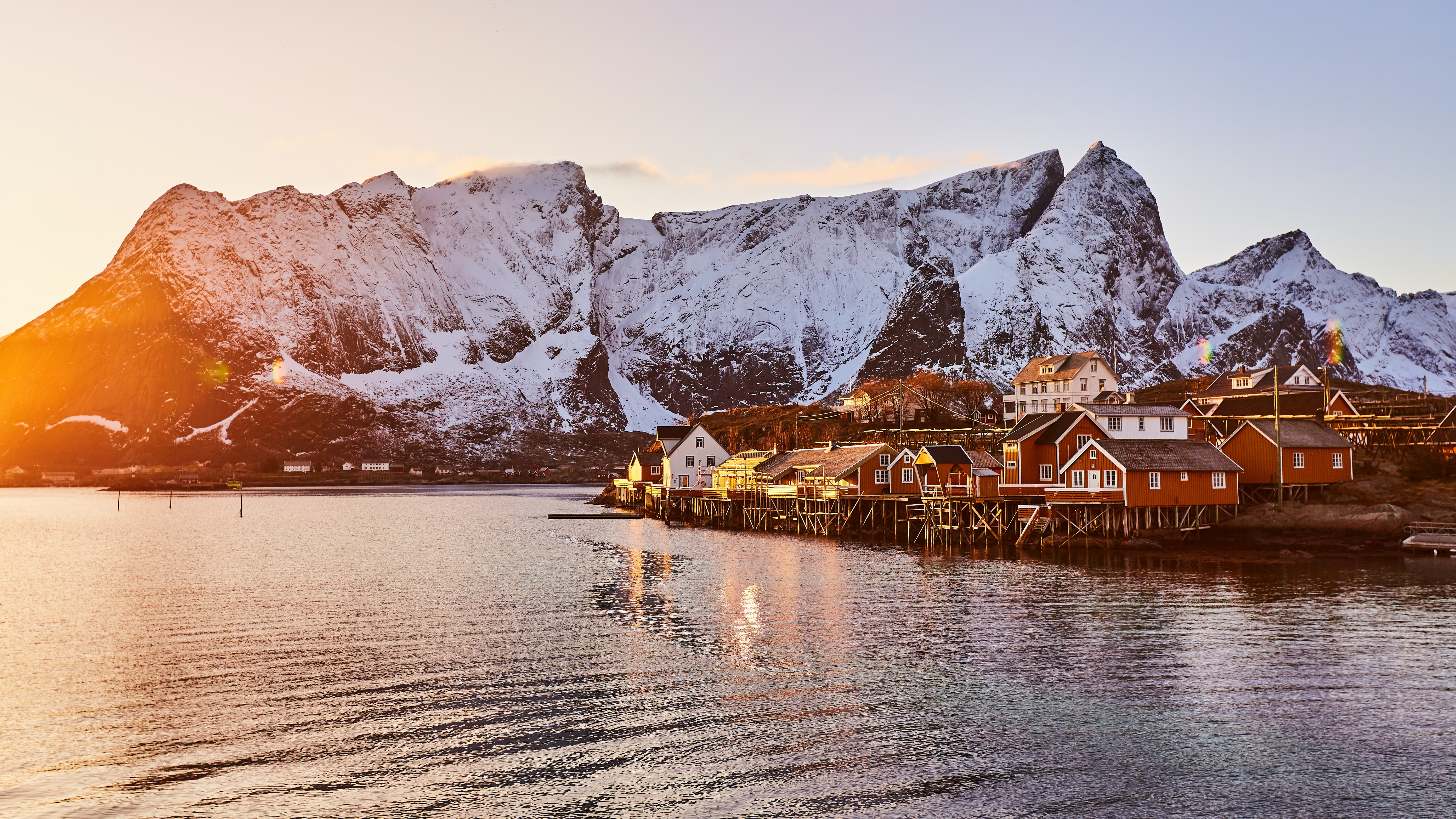 sunlight on a small Norwegian village and mountains 