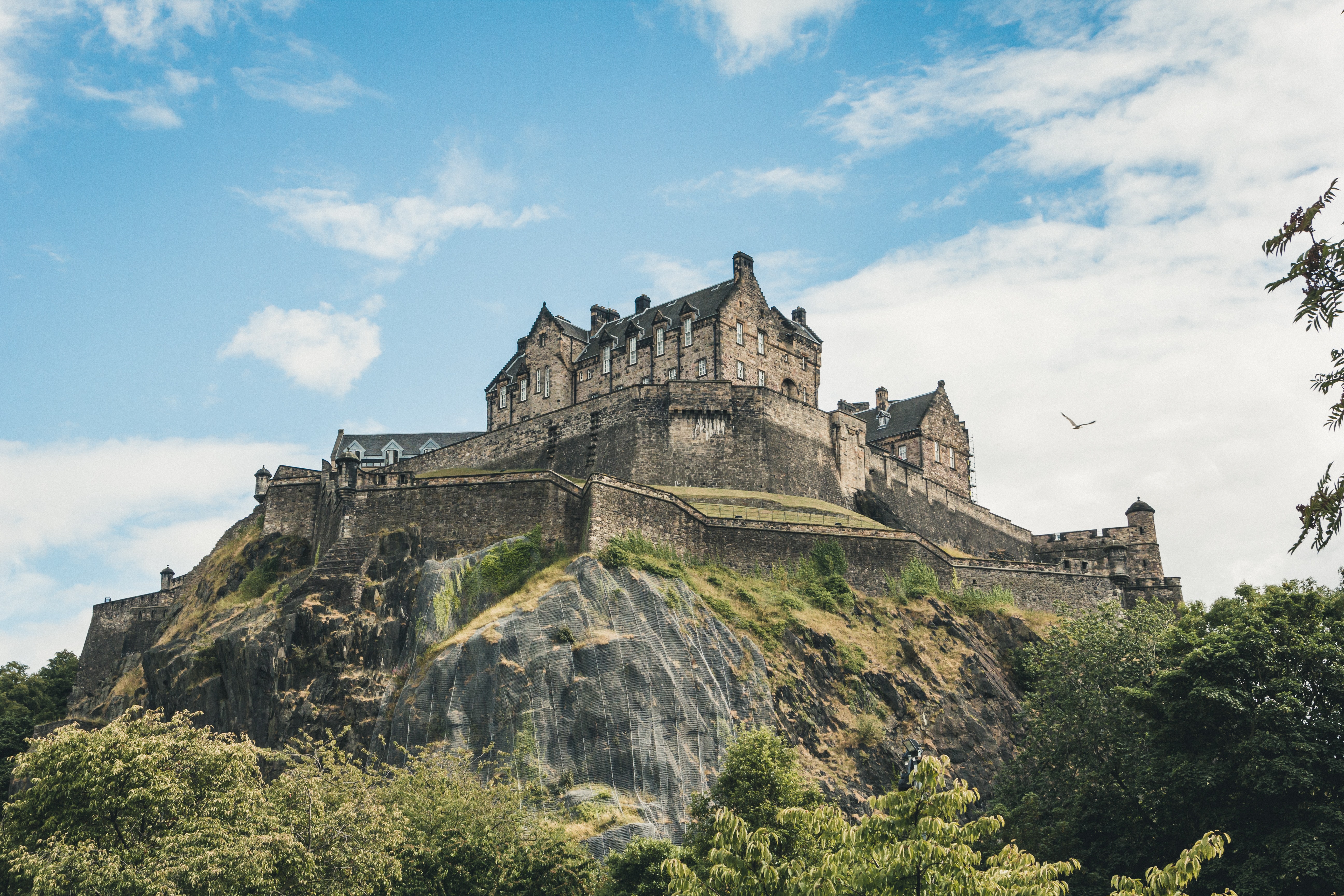 Medieval Edinburgh castle on a hill, pictured from below