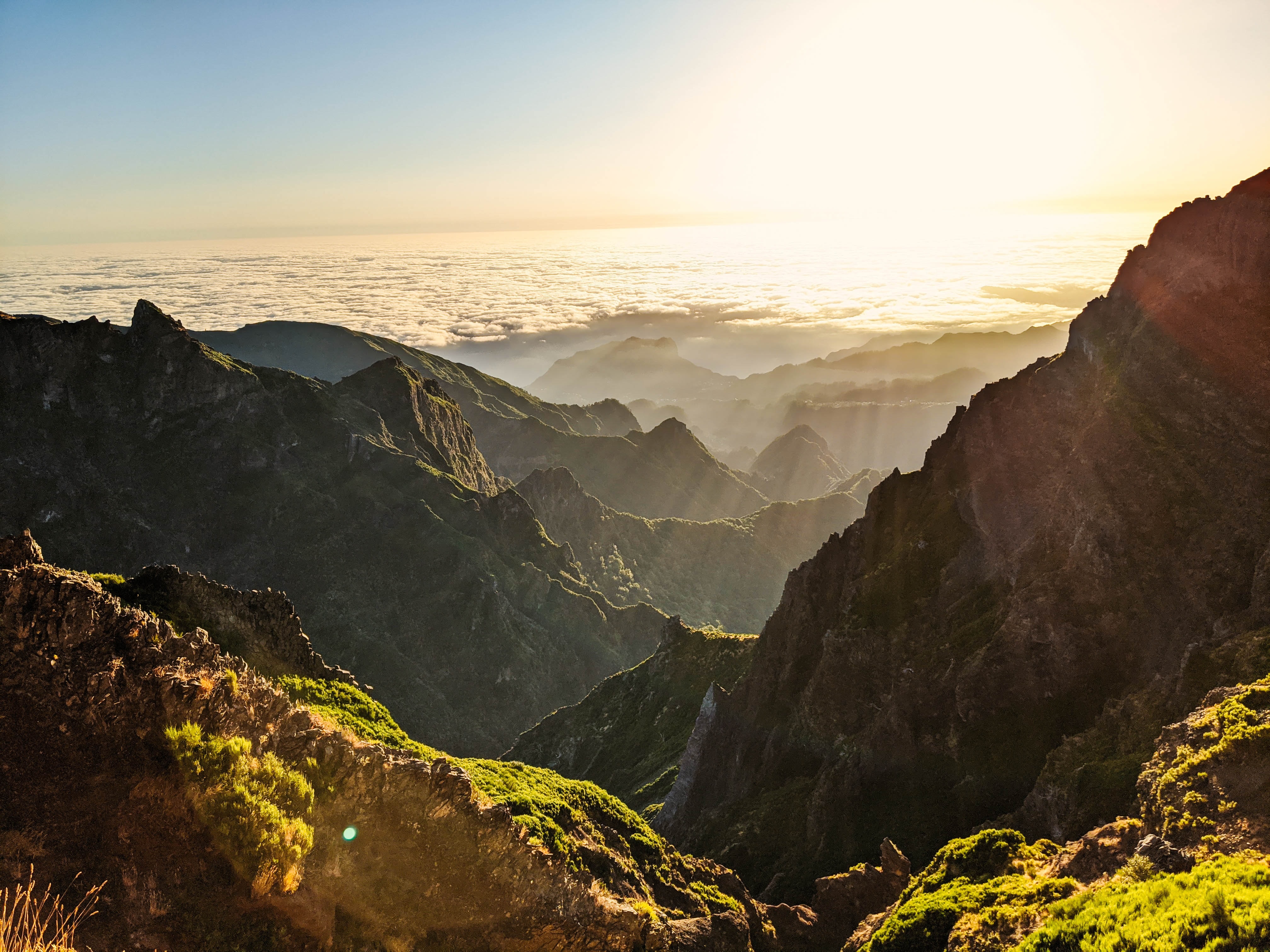 Mountains with clouds and sun rays above