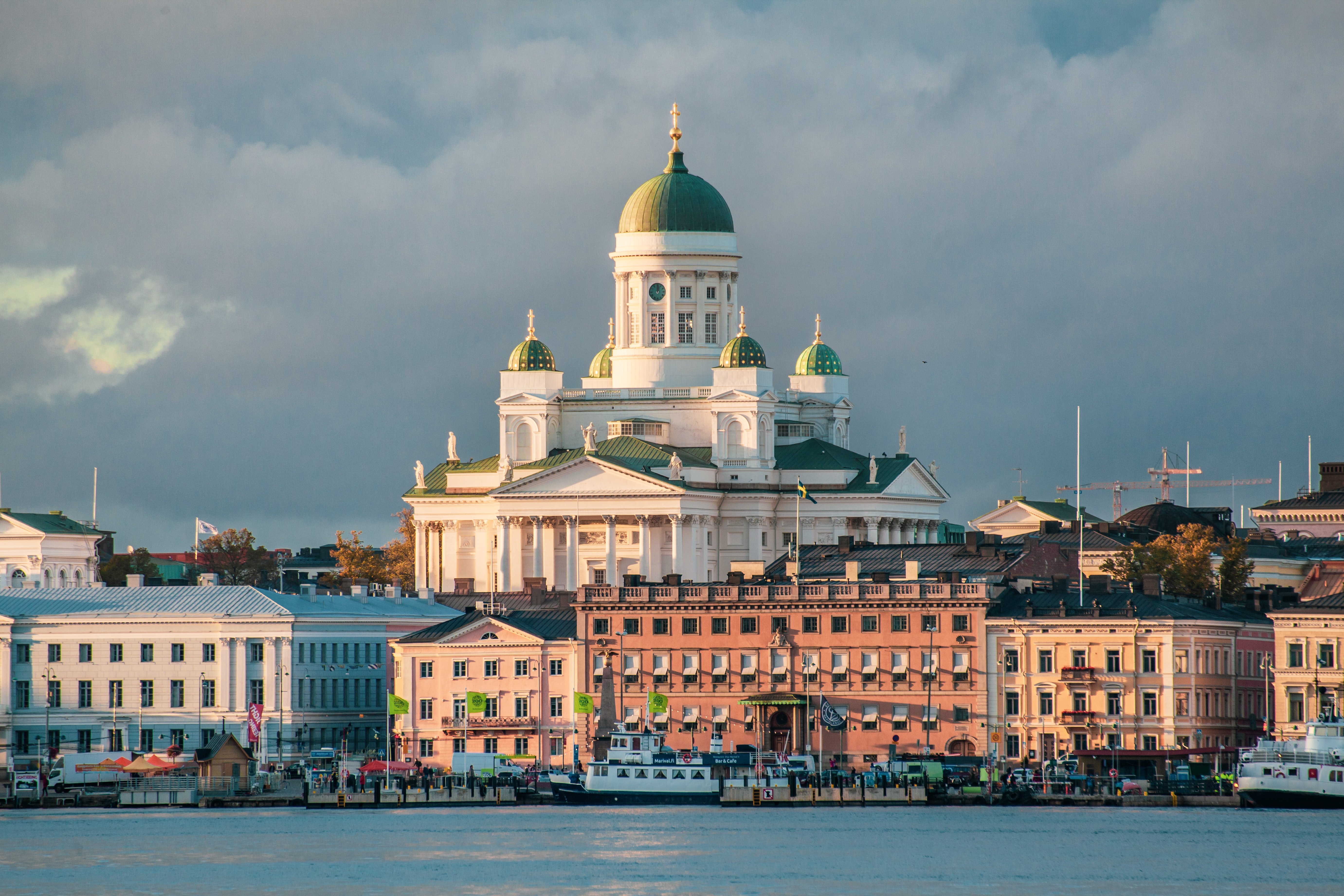 A white church on a hill surrounded by old buildings in Helsinki