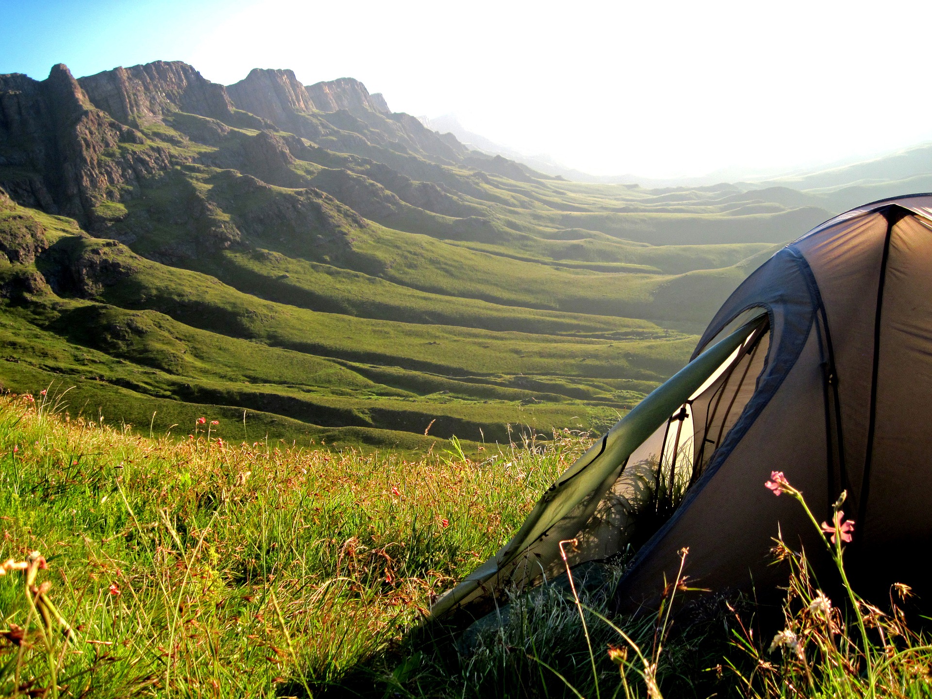 A tent in a green hilly landscape