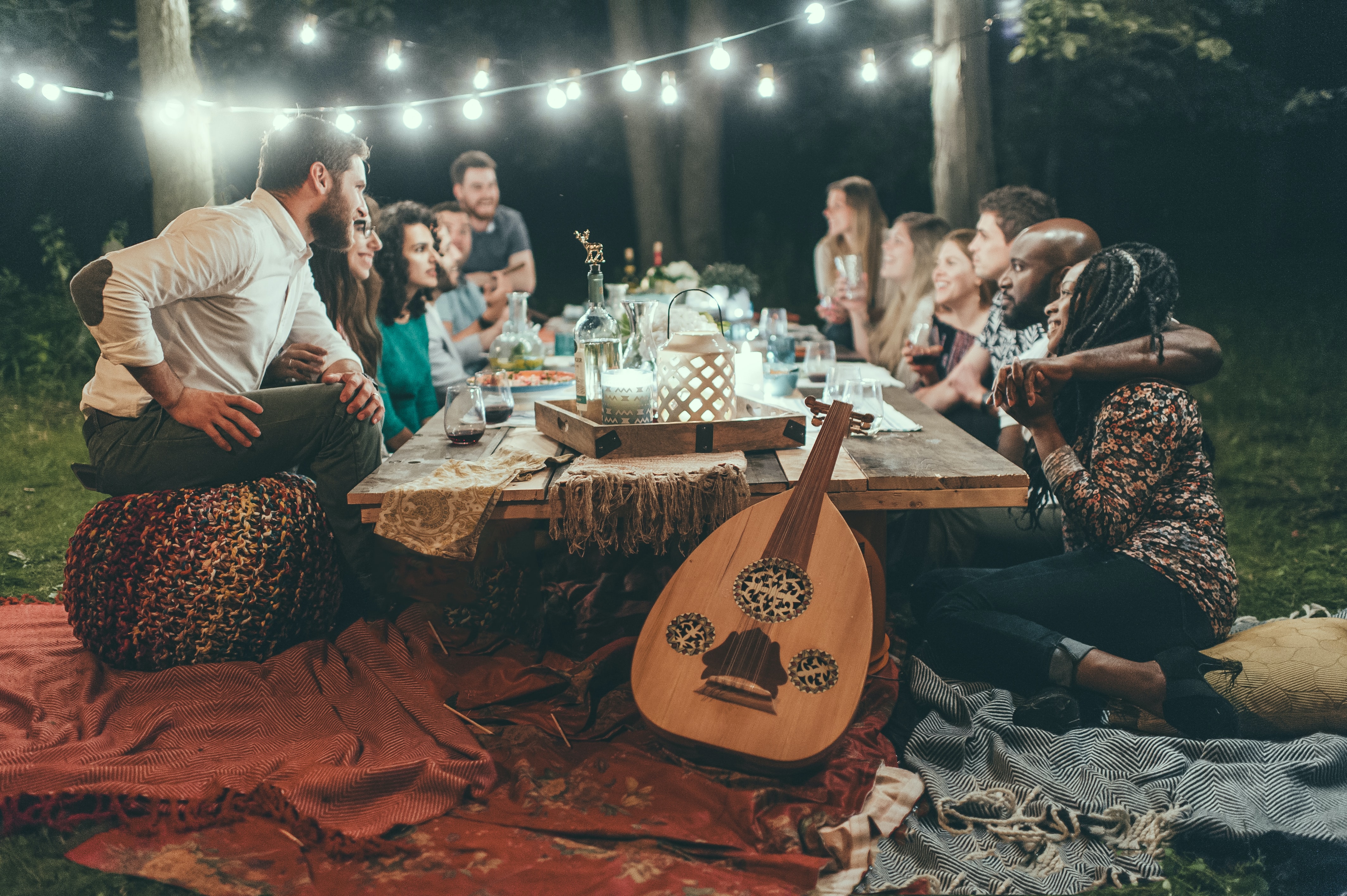 Many people sitting around a wooden table on the perfect group trip.