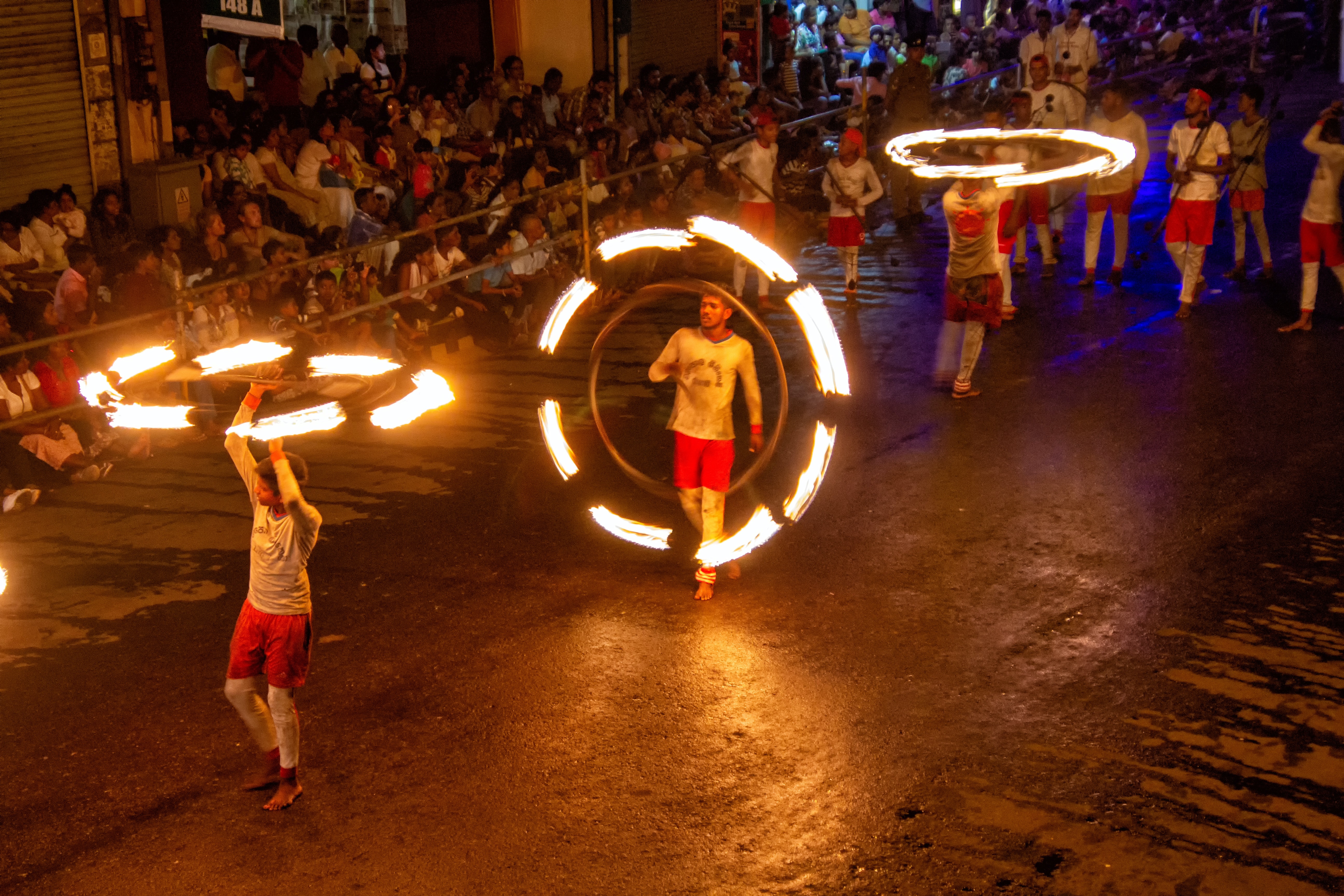 Men walking around playing with fire in this Sri Lanka travel guide.