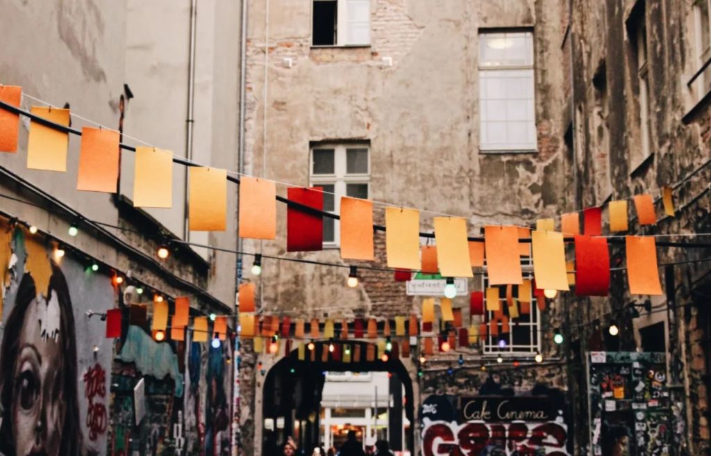 Fairy lights and flags in an alley in Berlin a low budget travel destination