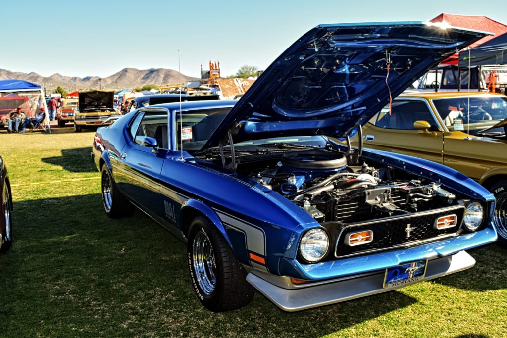 a blue mustang car with the bonnet up ready for a road trip 