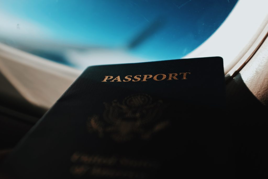 a passport that is lying in front of a plane window