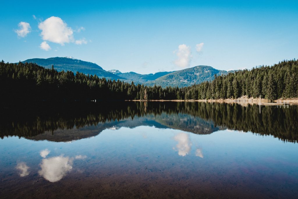 landscape photo of trees against the Lost Lake, which is in Whistler the amazing top spot Vancouver location