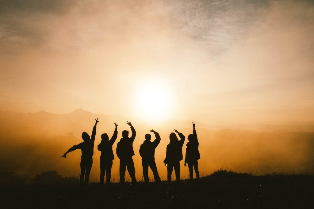 friends together standing in a beautiful sunset