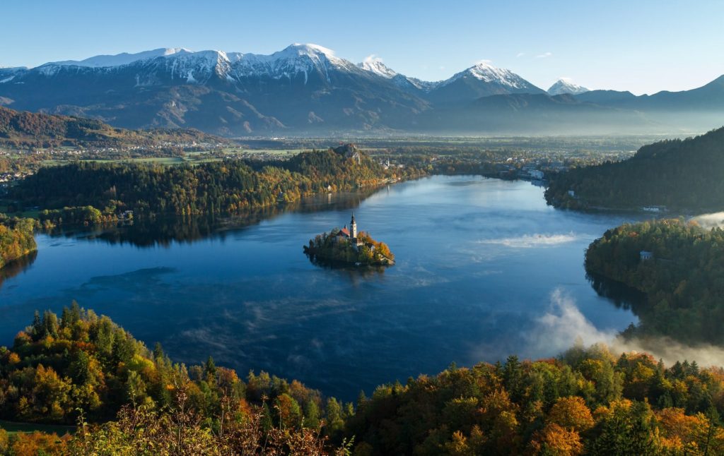 Lake Bed In Slovenia Looking Over The Mountain Range autumn destination in Europe