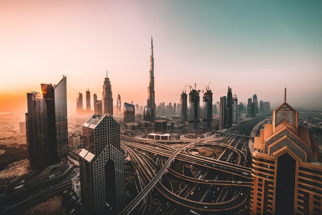 A purple sky above the infrastructure and skyscrapers of Dubai.