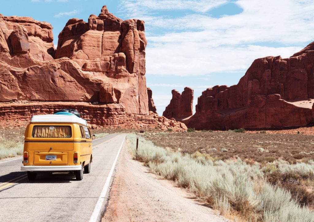 The best travel movies and books with a VW yellow van driving through mountain ranges