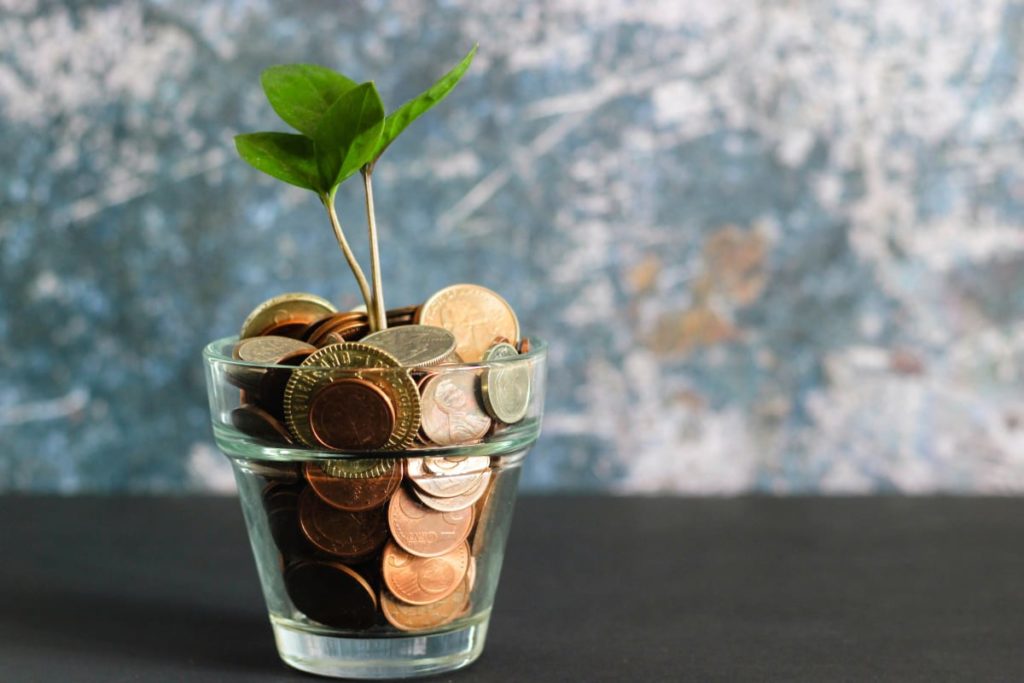 a glass with coins in it to become a TripLeader