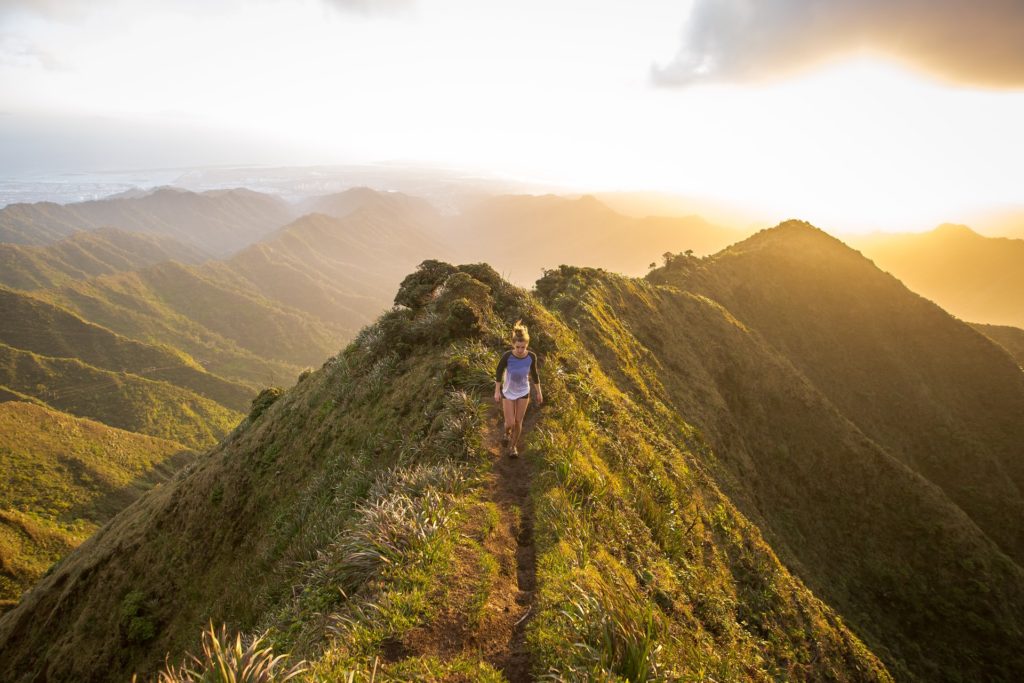 Woman, solo traveling and hiking across the beautiful landscapes