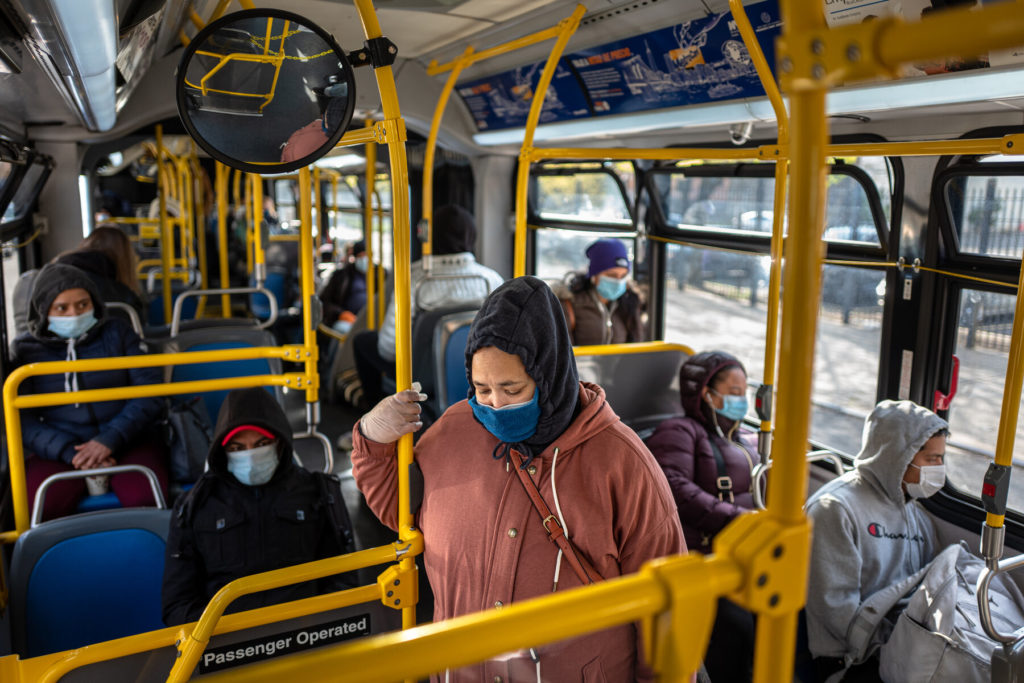 a bus with people that are wearing masks in Dubais travel news