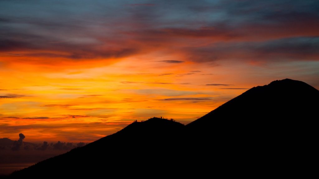 A mountain range during a sunset is the perfect place to explore alone as a woman