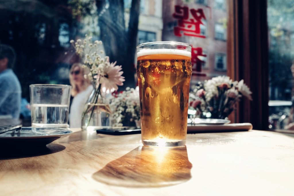 a glass of full beer on a table best beer tours in Germany