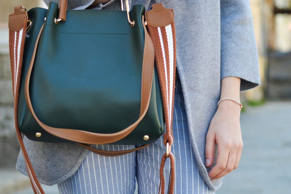 Packing your hand luggage is important. A women standing, holding a bag. 